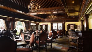 A spacious dining area with high wooden ceilings, chandeliers, and multiple dining tables and chairs. - Hotel Annapurna (Kathmandu)