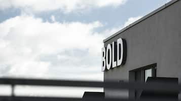 A building with a sign that reads "BOLD" on its facade.