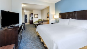 Una camera d'albergo con un letto grande, una TV a schermo piatto, una scrivania e una sedia.