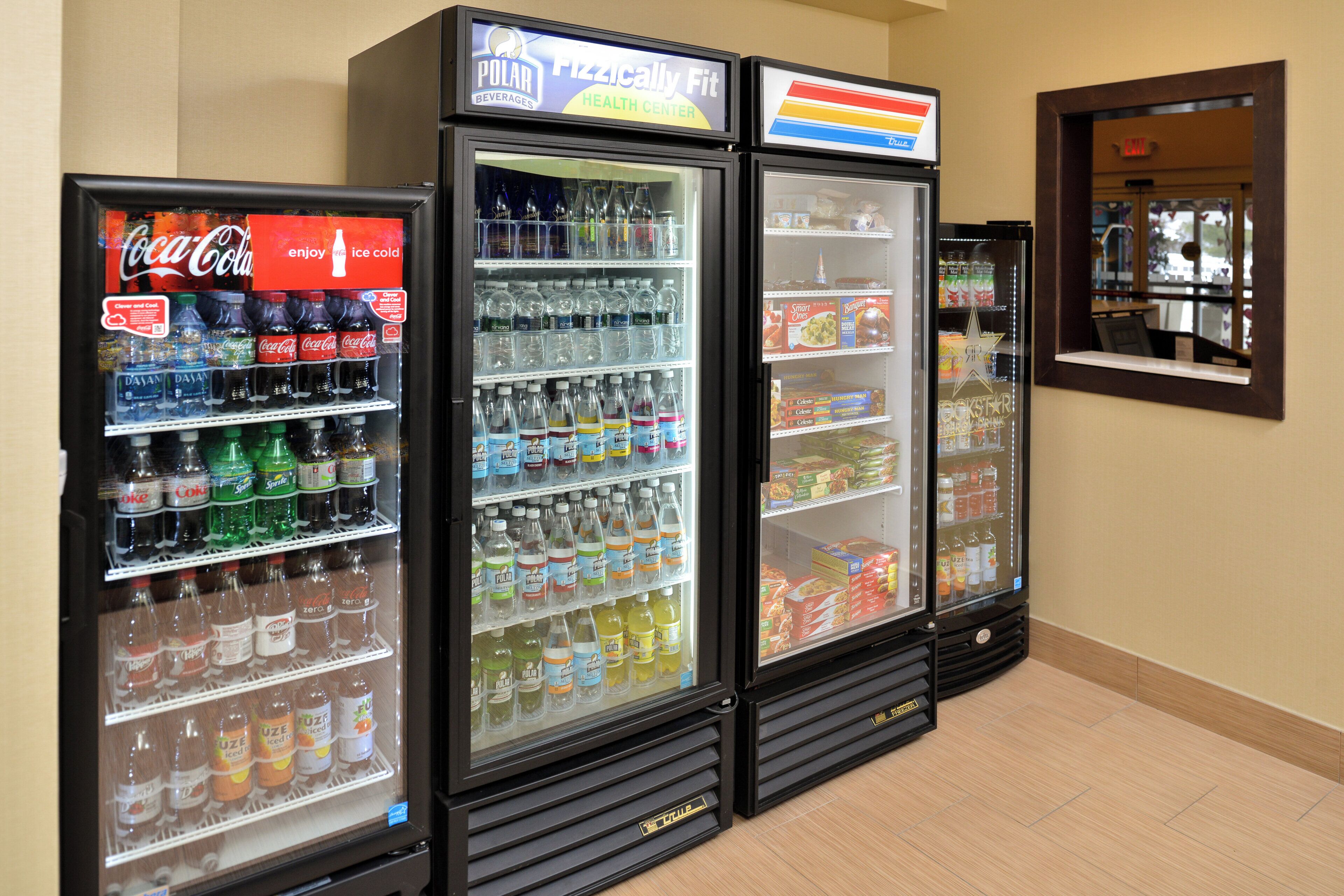 A row of beverage vending machines with various drink options.