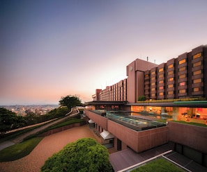 A modern hotel with a rooftop pool, a landscaped garden, and a city view. - Shiroyama Hotel Kagoshima (Kagoshima)