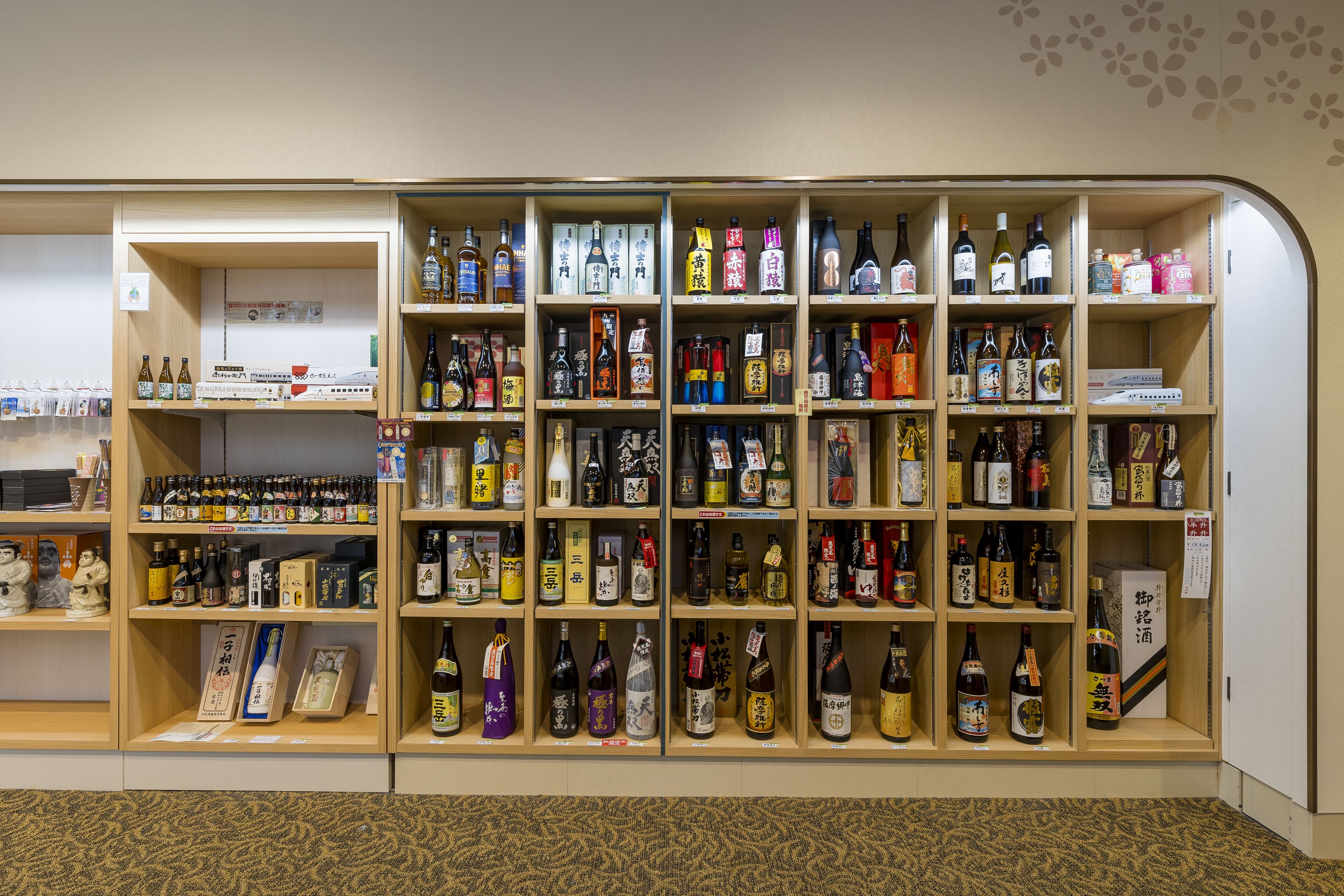 A liquor store with shelves stocked with various bottles of alcohol.