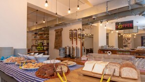 A buffet area with various food items, including bread, pastries, and a meat dish. - Rumours Inn (Istanbul)