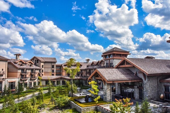 A hotel with multiple buildings, a courtyard, and a clear blue sky.