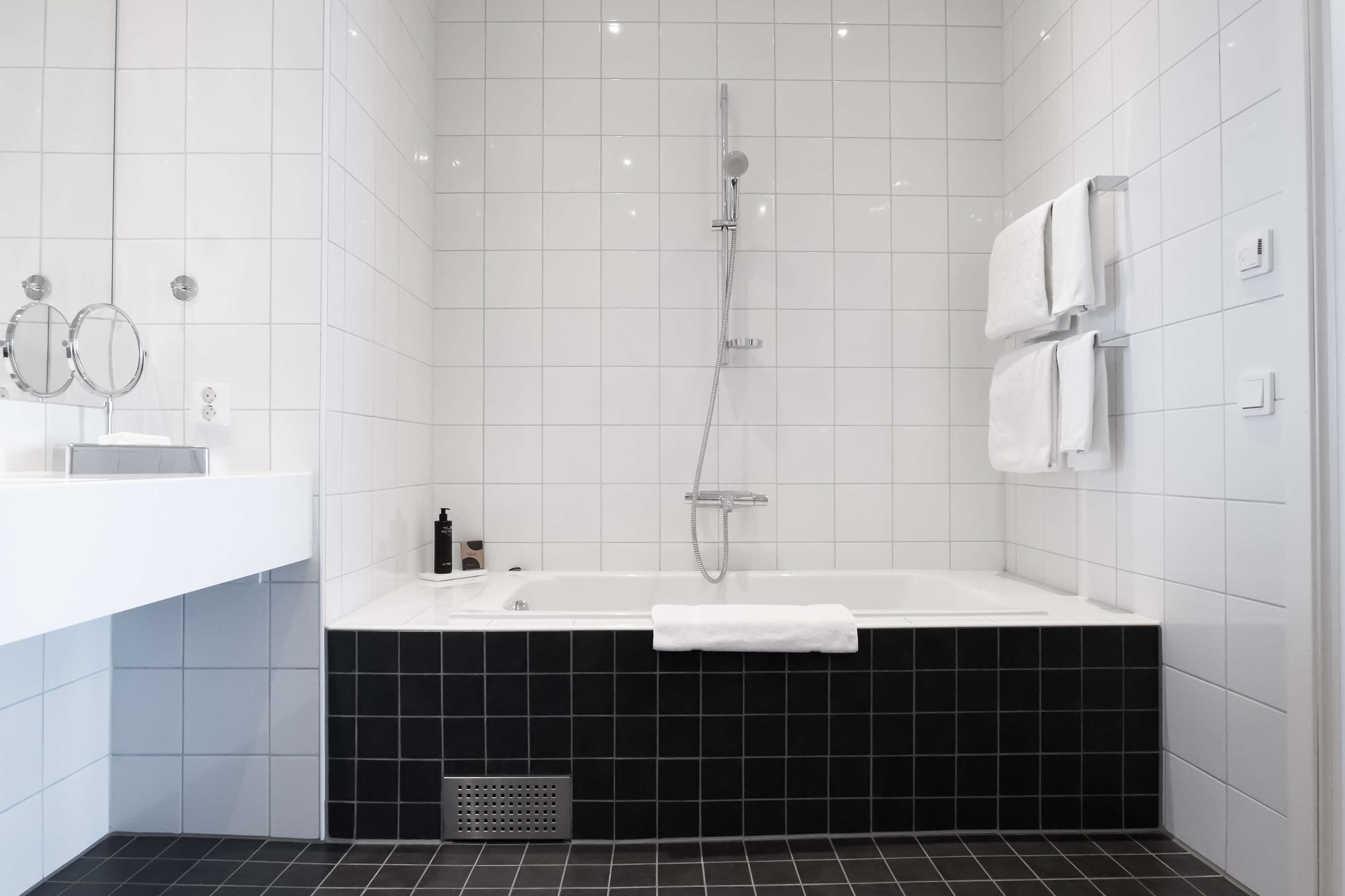 junior suite, 1 king bed, non smoking | bathroom | eco-friendly toiletries, hair dryer, heated floors, towels