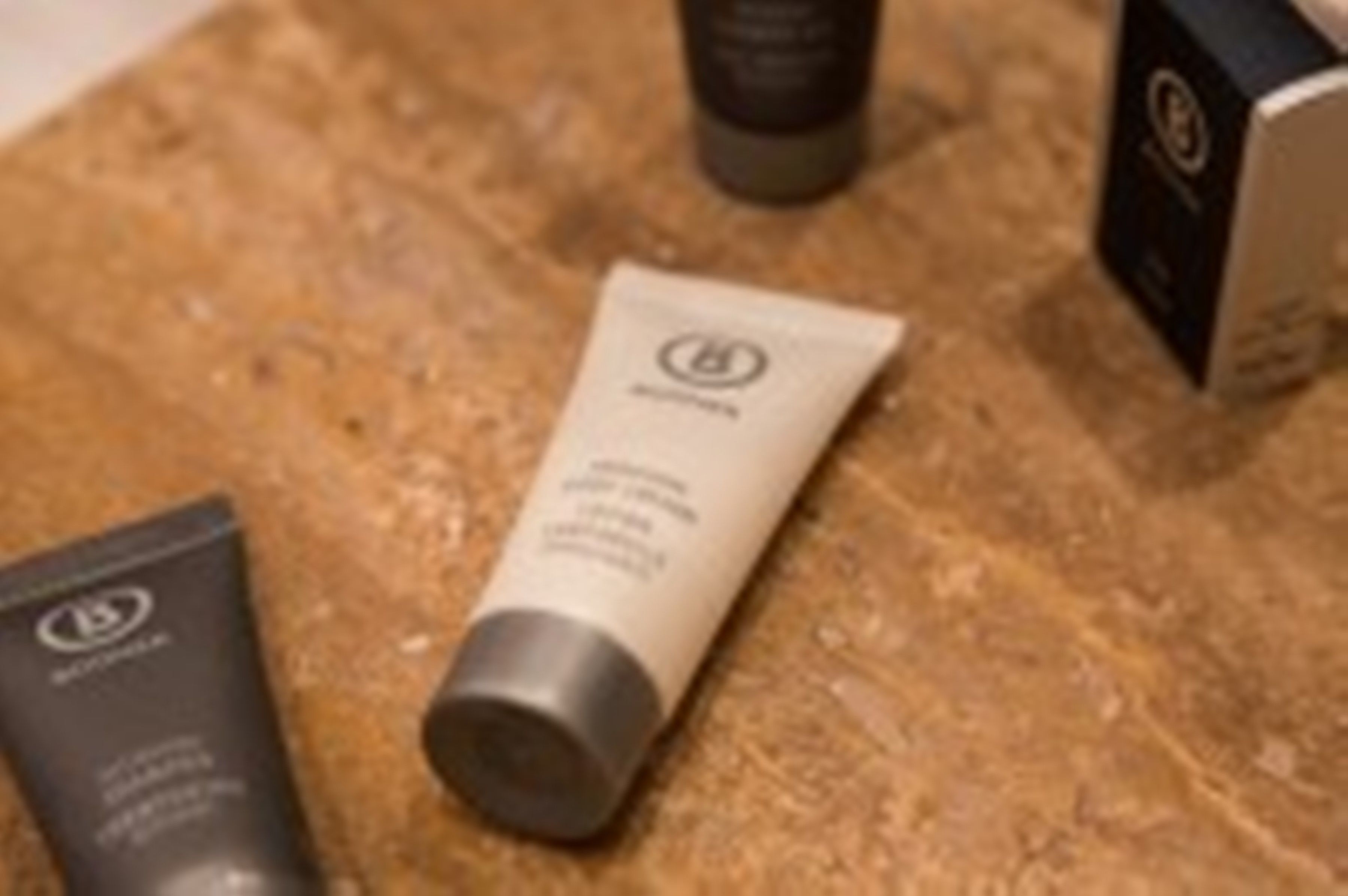 A countertop with three skincare products, including a tube labeled "L'Occitane."