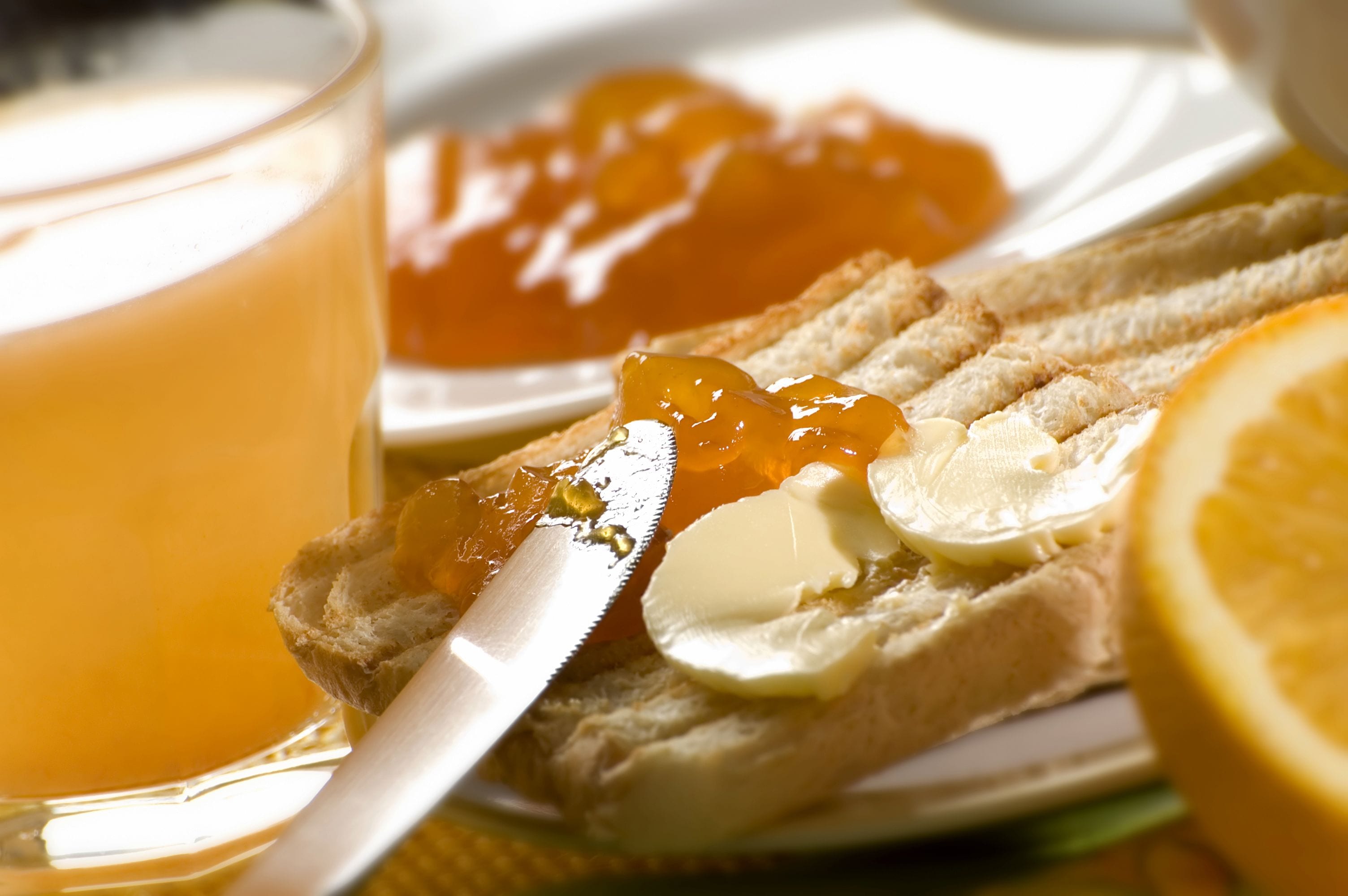 A breakfast setting with toast, butter, and jam.