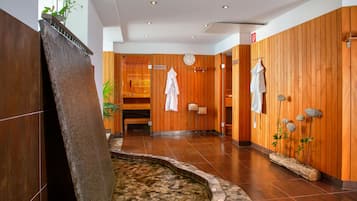 Relax in a serene spa area with a soothing water feature and comfortable seating.