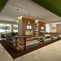 Un moderno vestíbulo de hotel con una zona de desayuno autoservicio, detalles de madera e iluminación colgante verde.