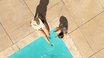 Outdoor pool, open 9:00 AM to 10:00 PM, pool loungers