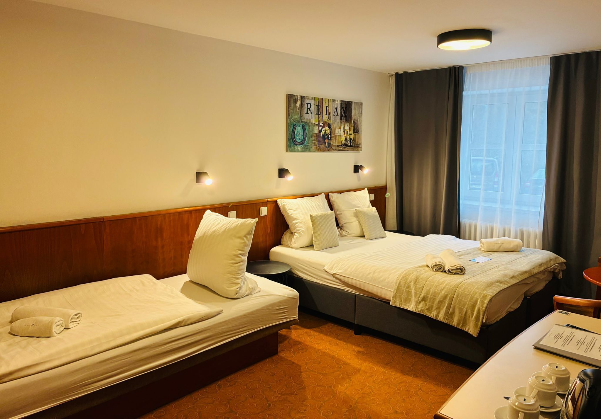 Economy Triple Room | Minibar, in-room safe, desk, iron/ironing board