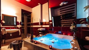 Ein modernes Badezimmer mit einer großen Badewanne, einem Waschbecken und einem Spiegel.