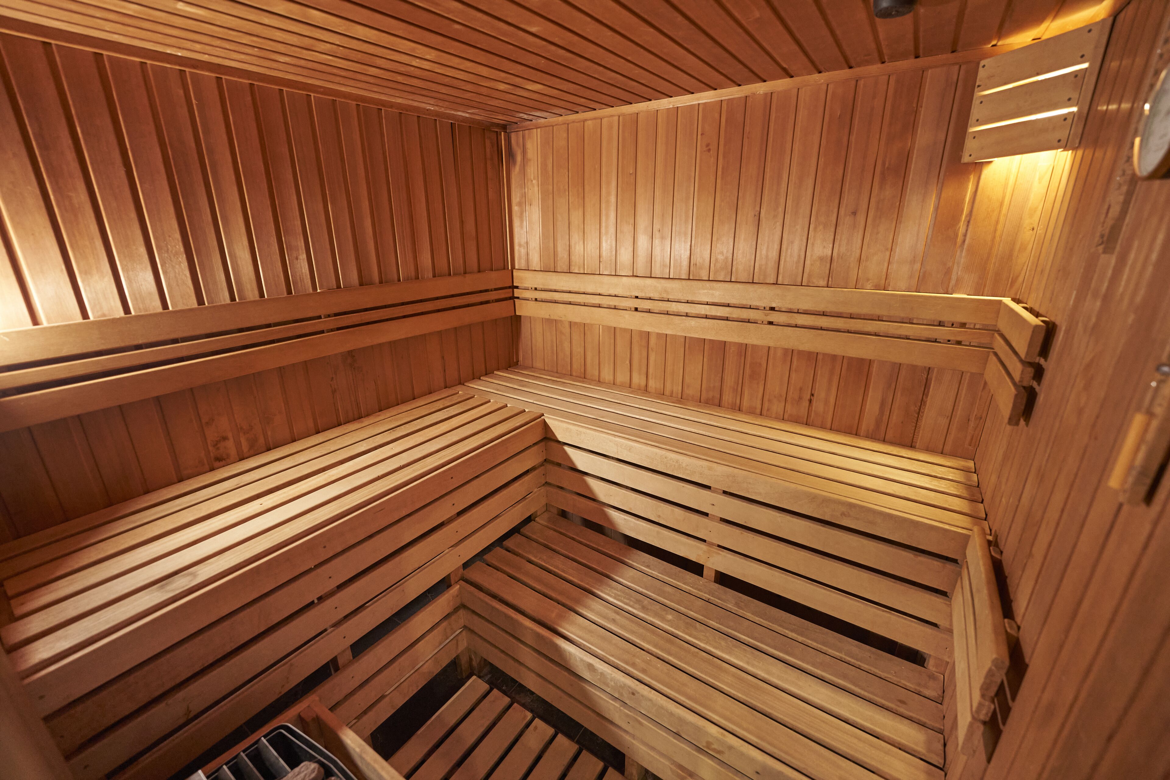 A sauna with wooden benches and slatted walls.
