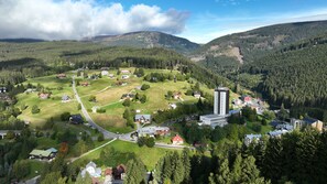 A rural village with a prominent church, a main road, and scattered houses. - Hotel Chata Orlik all inclusive (Pec pod Snezkou)