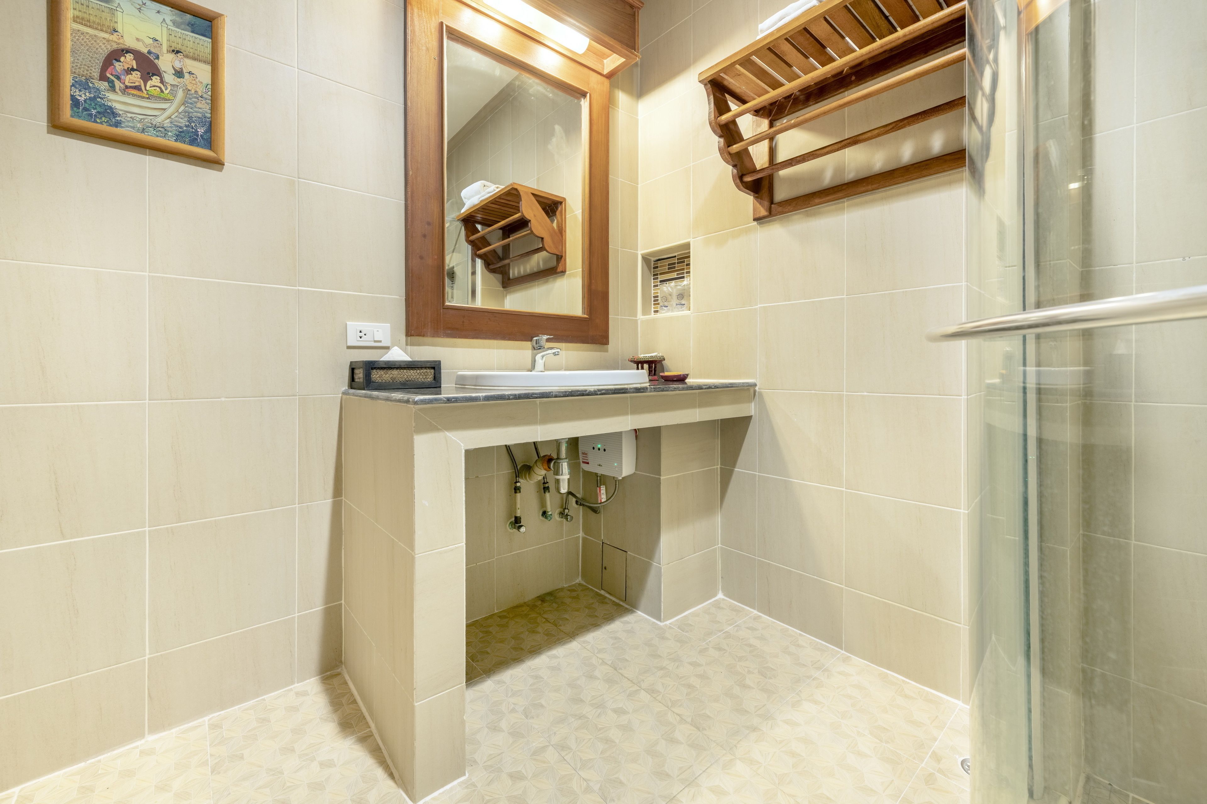 A bathroom with a sink, mirror, and shower.