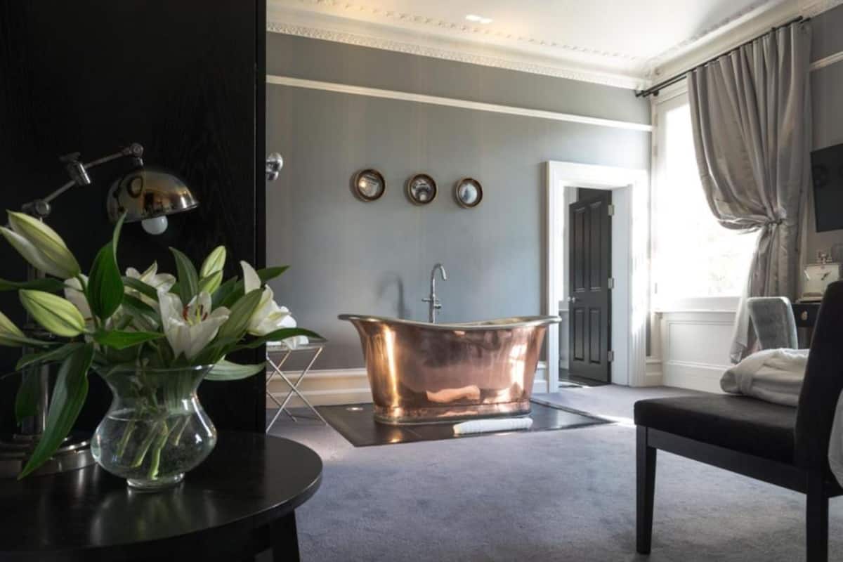 separate bathtub and shower, rainfall showerhead, designer toiletries