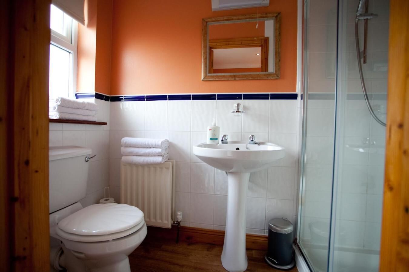 A bathroom with a toilet, sink, and shower.