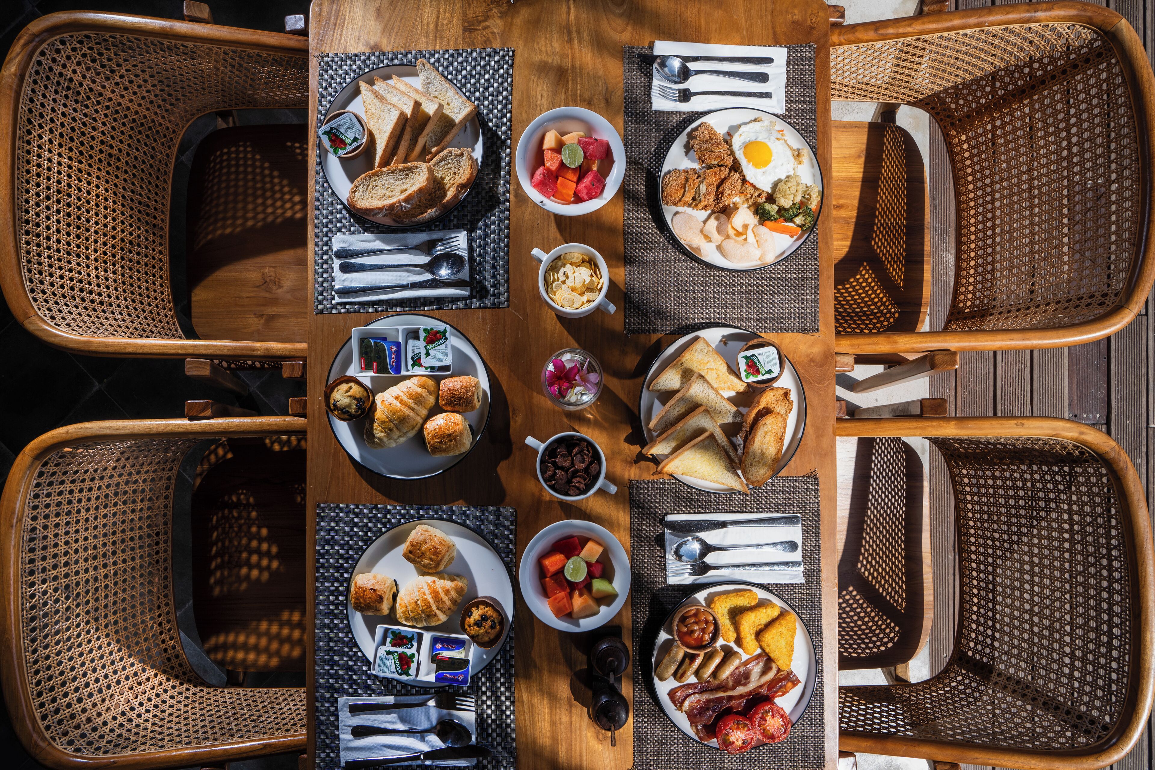 A breakfast buffet with various food items and seating arrangements.