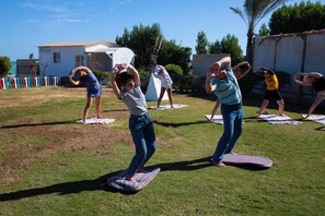 A group of people exercising on mats outdoors. - Magic Beach Resort (Hurghada)