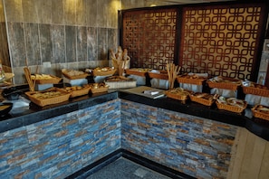 A buffet area with various food items and baskets.