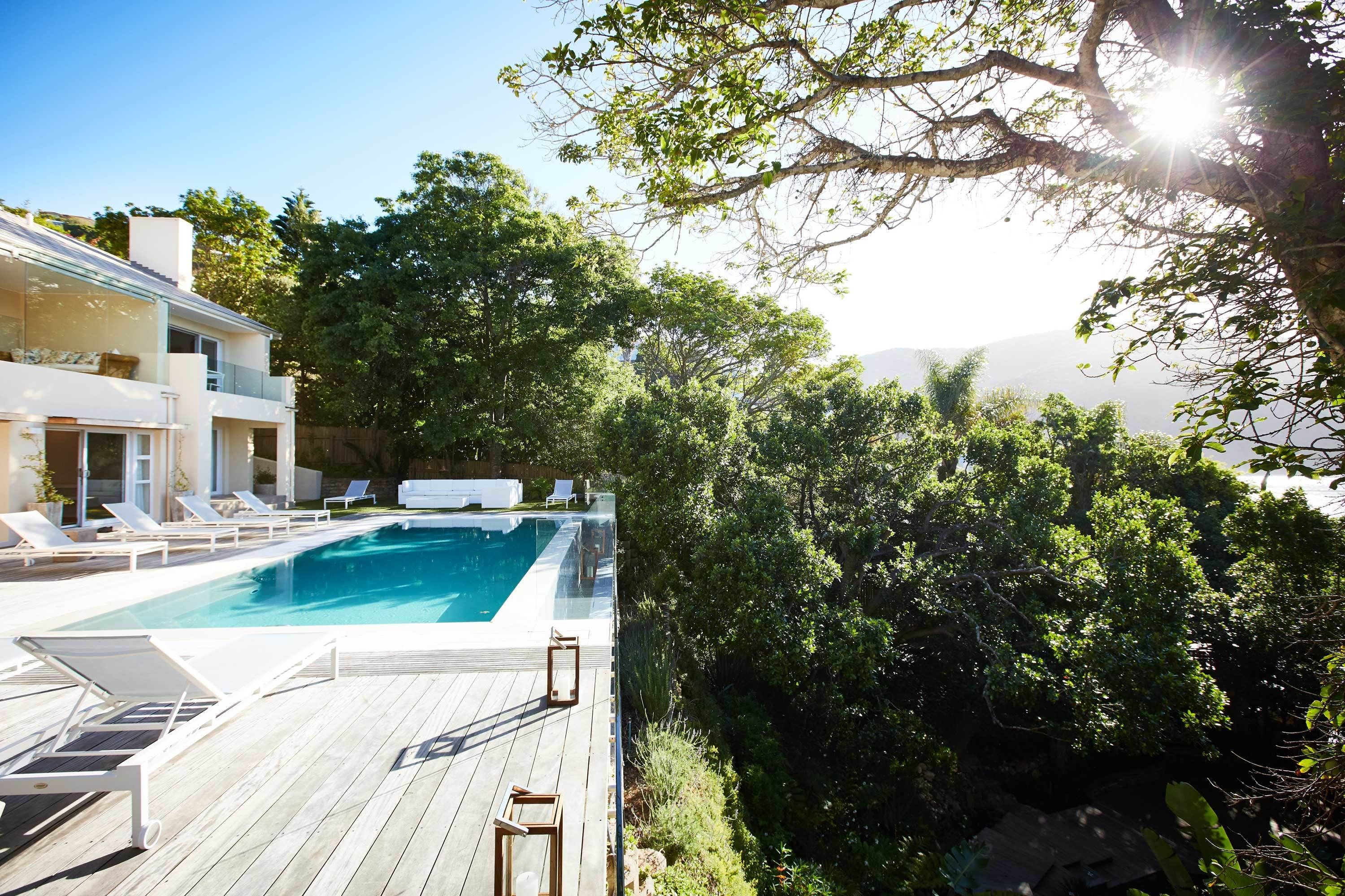 Outdoor pool, an infinity pool, pool umbrellas, sun loungers