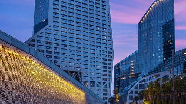 A modern high-rise building with a sign reading "ASCOTT" at the top.