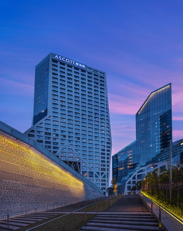 A modern high-rise building with a sign reading "ASCOTT" at the top.