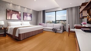 A modern hotel room with a large bed, a sofa, a desk, and a view of the city. - Ascott Raffles City Chengdu (Chengdu)