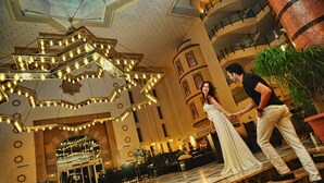 A grand lobby with a chandelier, seating area, and a staircase. - Mukarnas Spa & Resort (Alanya)