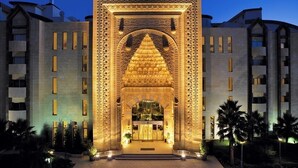 A hotel entrance with intricate architectural details, a central archway, and a symmetrical facade. - Mukarnas Spa & Resort (Alanya)