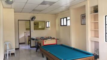 Enjoy games and views from this room with a pool table, foosball table, and window overlooking the outside.