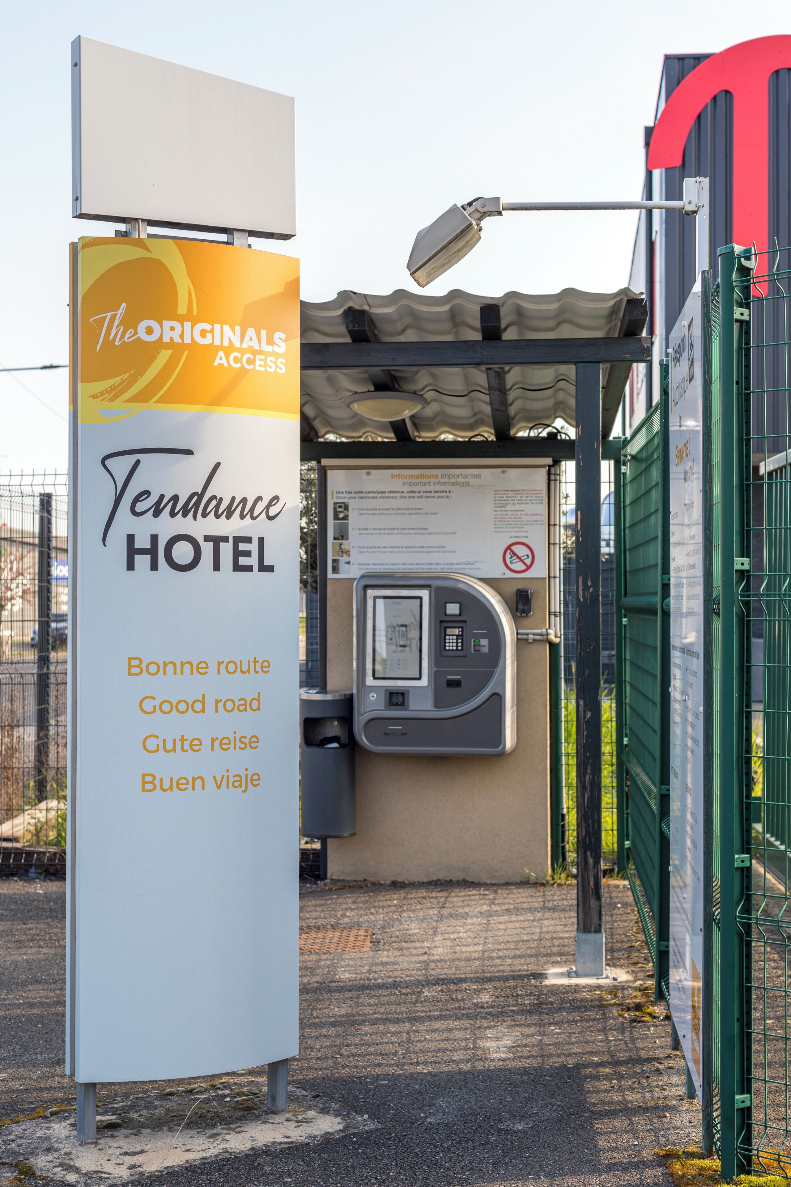 A Tendance Hotel sign with multilingual directions and a payment kiosk.