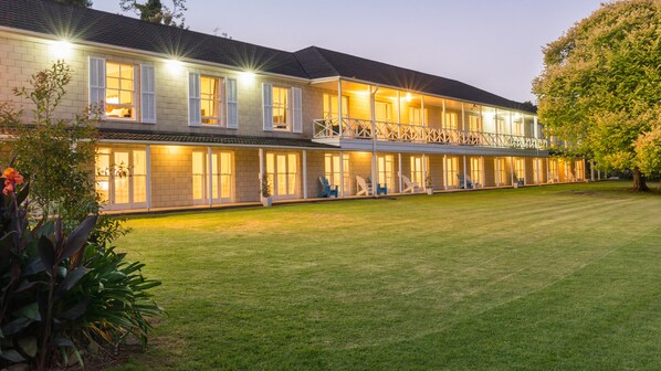 Stunning two-story building with a symmetrical facade and well-manicured lawn.