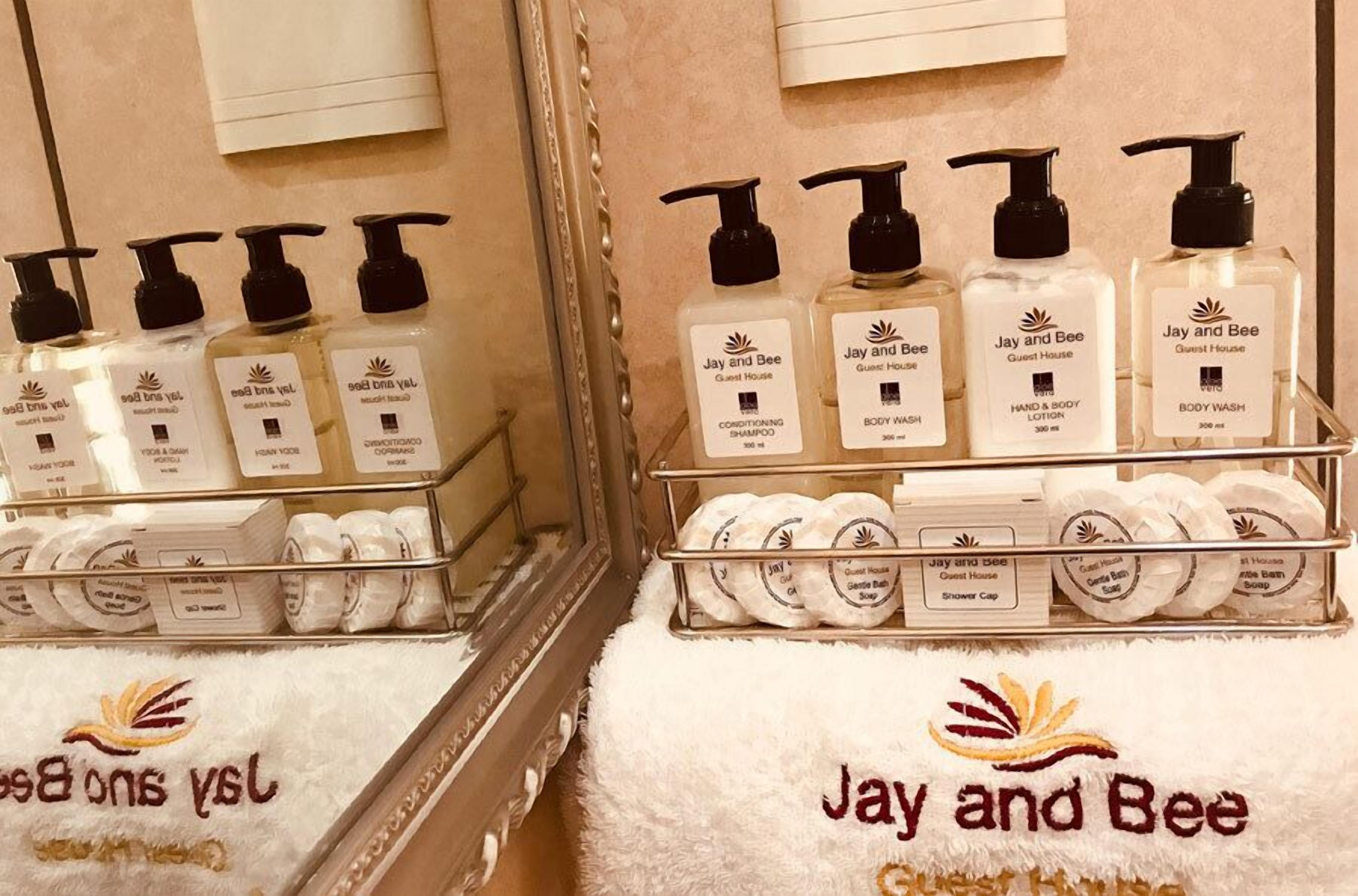 A bathroom with toiletries including shampoo, body wash, and shower cap.