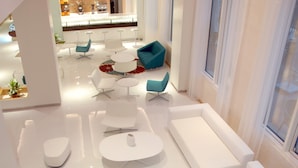 A modern interior with white furniture, a bar area, and large windows. - Ibis Yanbu Saudi Arabia (Yanbu)