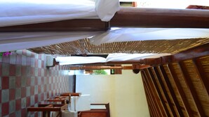 Ein Zimmer mit kariertem Boden, Holzmöbeln und einem großen Fenster.