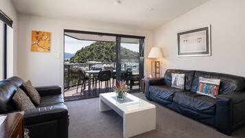 Panoramic Apartment, 2 Bedrooms, Sea View | Living room | 36-inch LCD TV with digital channels, TV, iPod dock