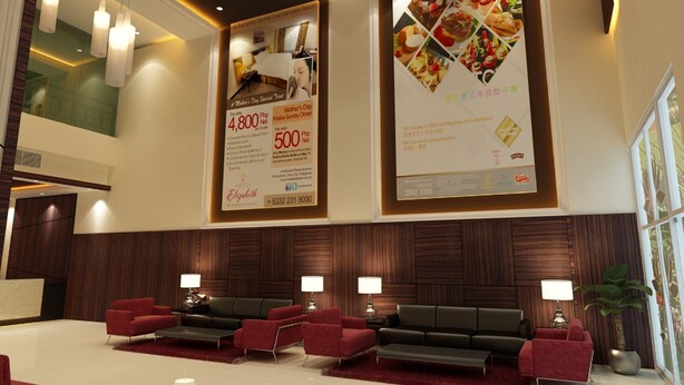 A hotel lobby with a reception desk, red and black seating, and large posters advertising Mother's Day and a special event. - Hallmark Regency Hotel - Johor Bahru (Johor Bahru)