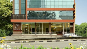 A modern building with a glass facade, a sign reading "Hallmark Regency Hotel," and multiple flags on top. - Hallmark Regency Hotel - Johor Bahru (Johor Bahru)