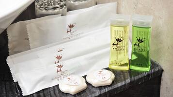 Toiletries including shampoo and soap on a tray.