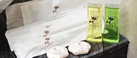 Toiletries including shampoo and soap on a tray.