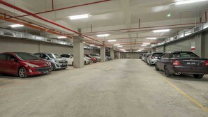 A multi-level parking garage with cars parked on both levels. - Canada Easy Lodge (Burnaby)