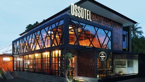 A modern hotel with a prominent sign reading "OSSOTEL". - Ossotel Legian Bali (Legian)