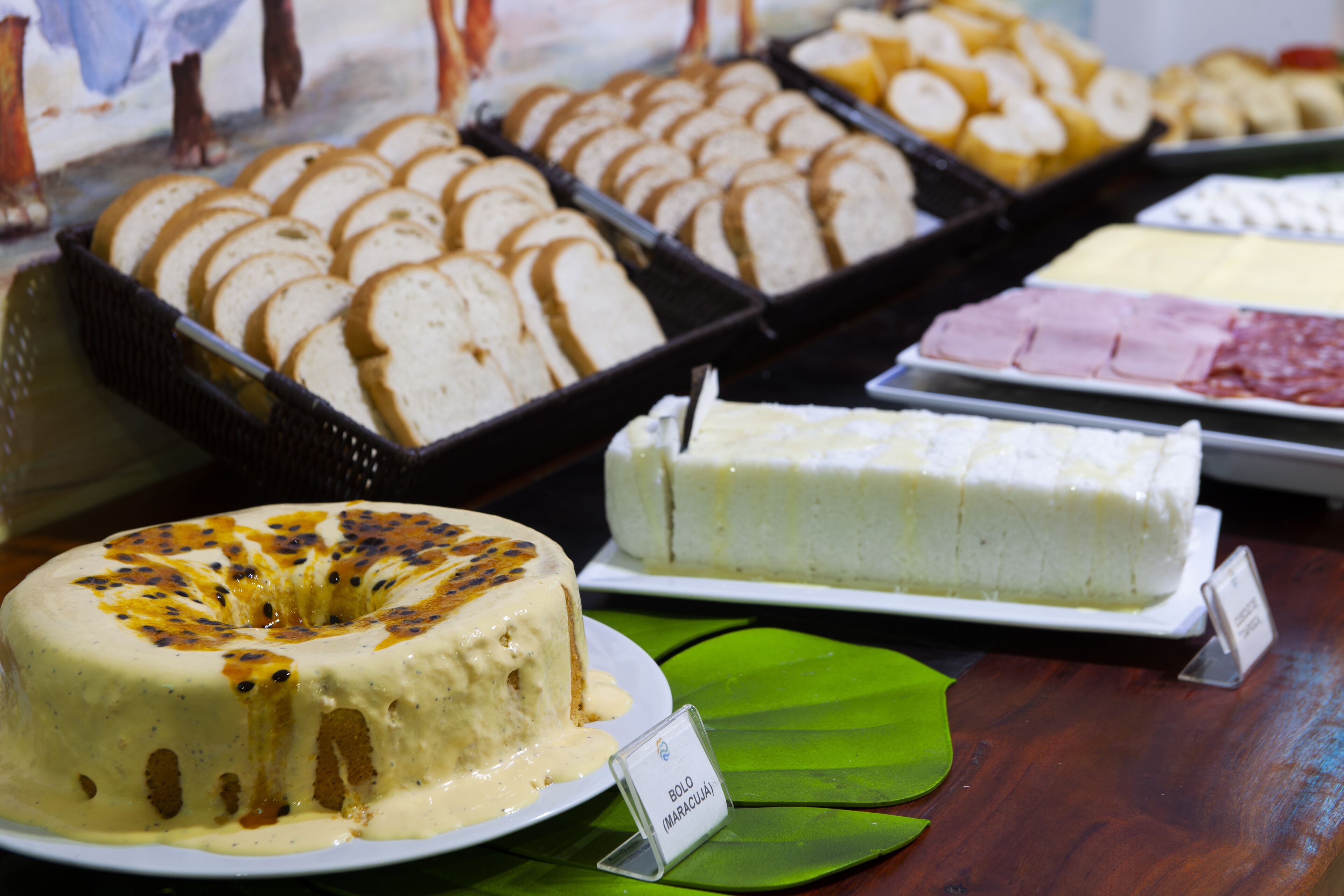 A display of various baked goods including bread, cakes, and pastries.