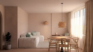 Un dormitorio moderno con cama, mesita de noche y un rincón comedor con sillas y una mesa.