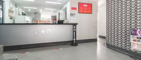A reception area with a CYO sign, a patterned wall, and a counter with various items.