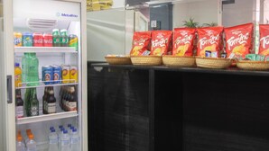 A vending machine stocked with snacks and beverages, including Doritos and various sodas. - Mangabeiras Hotel (Goiania)
