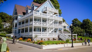A multi-story building with a prominent balcony and a staircase leading to the upper levels.