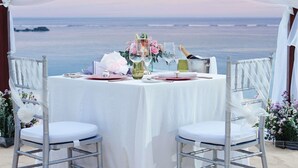 A table set for two with a view of the ocean, white chairs, and a tent overhead. - Sofitel Bali Nusa Dua Beach Resort (Nusa Dua)