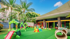 A playground with a slide, climbing structures, and a tunnel. - Sofitel Bali Nusa Dua Beach Resort (Nusa Dua)